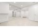 Bright, spacious basement with mirrored wall and wood-look tile flooring at 63 S Jackson St, Denver, CO 80209