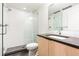 Modern bathroom with white subway tile shower, dark countertop, and glass enclosure at 63 S Jackson St, Denver, CO 80209