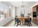 Modern dining room with a round wooden table and black chairs at 63 S Jackson St, Denver, CO 80209