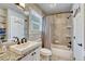 Bathroom featuring a granite countertop vanity, tiled tub and shower, and unique lighting at 970 Bend In The Trail Rd, Monument, CO 80132