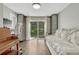 Bright bedroom with hardwood floors, a sliding glass door to the backyard, and built-in storage at 970 Bend In The Trail Rd, Monument, CO 80132