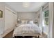 Comfortable bedroom featuring a double bed, closet and large window with sheer curtains at 970 Bend In The Trail Rd, Monument, CO 80132