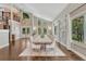 Bright dining room with high ceilings, statement windows, and a large table with seating for ten at 970 Bend In The Trail Rd, Monument, CO 80132