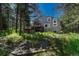 A picturesque exterior view of the multi-story house with a deck and mature trees at 970 Bend In The Trail Rd, Monument, CO 80132