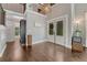 Welcoming foyer with dark wood floors, double front doors, and wrought iron staircase detail at 970 Bend In The Trail Rd, Monument, CO 80132