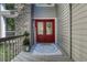 Inviting front entrance with a red double door, stone accents, and a 'Welcome' mat at 970 Bend In The Trail Rd, Monument, CO 80132