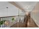 Second story view of the beautiful hallway, hardwood floors, iron railing and an open floorplan at 970 Bend In The Trail Rd, Monument, CO 80132