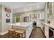 Charming kitchen featuring a center island with seating and white cabinetry at 970 Bend In The Trail Rd, Monument, CO 80132