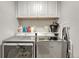 A laundry room featuring a side-by-side washer and dryer and overhead cabinets at 970 Bend In The Trail Rd, Monument, CO 80132