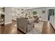 Open concept living room with hardwood floors, modern furnishings, and seamless flow to a well-equipped kitchen at 970 Bend In The Trail Rd, Monument, CO 80132