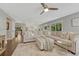 Open living space with a comfortable sectional, hardwood floors, and view to the kitchen at 970 Bend In The Trail Rd, Monument, CO 80132