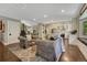 Bright, open-concept living area featuring hardwood floors, comfortable seating, and a modern kitchen with stainless appliances at 970 Bend In The Trail Rd, Monument, CO 80132