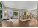 Open-concept living and dining area with hardwood floors and plenty of natural light at 970 Bend In The Trail Rd, Monument, CO 80132
