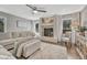 Bright living room featuring a cozy fireplace, hardwood floors, neutral color palette, and comfortable seating at 970 Bend In The Trail Rd, Monument, CO 80132