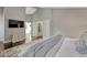 View of the main bedroom with hardwood floors, a TV, and doors to the main bathroom at 970 Bend In The Trail Rd, Monument, CO 80132