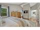 Vaulted ceiling primary bedroom featuring a dresser, a large window, and an ensuite bathroom at 970 Bend In The Trail Rd, Monument, CO 80132