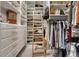 Custom walk-in closet with ample storage, shelving, drawers, and a rolling ladder at 970 Bend In The Trail Rd, Monument, CO 80132