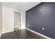 Bedroom with dark accent wall and hardwood floors at 2525 Arapahoe St # Rd108, Denver, CO 80205