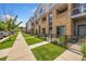 Modern townhome community with a paved walkway and landscaped lawns at 2525 Arapahoe St # Rd108, Denver, CO 80205