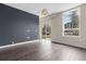 Living room with hardwood floors, a large window and a dark accent wall at 2525 Arapahoe St # Rd108, Denver, CO 80205