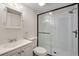 Bathroom with glass shower enclosure, vanity and a lighted mirror at 7845 Barbara Ann Dr # J, Arvada, CO 80004