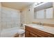 Well-lit bathroom featuring a tub with tile surround and granite vanity countertop at 7845 Barbara Ann Dr # J, Arvada, CO 80004