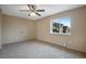 Neutral bedroom features carpeted floors, ceiling fan, and view of community at 7845 Barbara Ann Dr # J, Arvada, CO 80004