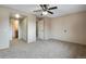 Neutral bedroom features carpeted floors, ceiling fan, and access to bathroom at 7845 Barbara Ann Dr # J, Arvada, CO 80004