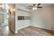 Living room features modern wood flooring, ceiling fan, and open access to kitchen at 7845 Barbara Ann Dr # J, Arvada, CO 80004