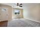 Cozy living room with neutral carpet, a ceiling fan and a bright window with view at 7845 Barbara Ann Dr # J, Arvada, CO 80004