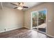 Bright living room features modern flooring, ceiling fan, and sliding door to patio at 7845 Barbara Ann Dr # J, Arvada, CO 80004