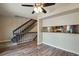 Open-concept living room features modern flooring, stairs, and view into kitchen at 7845 Barbara Ann Dr # J, Arvada, CO 80004