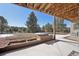 The concrete patio extends to a backyard with a garden bed under a covered patio area at 20120 Doewood Dr, Monument, CO 80132