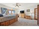 Bedroom with wood furniture, ceiling fan, and sliding door access to outdoor living space at 20120 Doewood Dr, Monument, CO 80132
