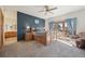 Bright bedroom with ensuite bathroom, outdoor access, and sitting area at 20120 Doewood Dr, Monument, CO 80132