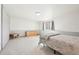 Minimalist bedroom with neutral carpet, a dresser, small table, and a well-lit window at 20120 Doewood Dr, Monument, CO 80132
