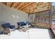 A charming covered patio area with cozy outdoor seating and a decorative lattice screen at 20120 Doewood Dr, Monument, CO 80132