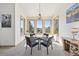Bright dining area featuring large windows offering stunning views and a charming chandelier at 20120 Doewood Dr, Monument, CO 80132