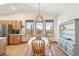 Bright dining area with natural light, wood floors, and views of the surrounding greenery at 20120 Doewood Dr, Monument, CO 80132