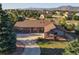 Charming ranch-style home with a brick facade, well-manicured lawn, and stunning mountain views in the background at 20120 Doewood Dr, Monument, CO 80132