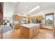 Bright kitchen featuring wood cabinets, a center island, and natural light from a skylight at 20120 Doewood Dr, Monument, CO 80132