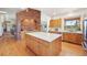 Large kitchen island with white countertop, stainless steel appliances, and a brick archway at 20120 Doewood Dr, Monument, CO 80132
