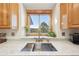 Modern kitchen sink with a view, light backsplash and stainless steel faucet at 20120 Doewood Dr, Monument, CO 80132