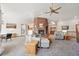 Spacious living room with a brick fireplace, carpet flooring, and plenty of natural light at 20120 Doewood Dr, Monument, CO 80132