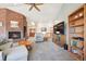 Cozy living room with a brick fireplace, skylight, and open layout, perfect for entertaining at 20120 Doewood Dr, Monument, CO 80132