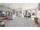 Spacious living room with large windows, bookshelves and sliding glass door to the exterior at 20120 Doewood Dr, Monument, CO 80132