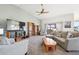 Bright living room with a vaulted ceiling, fireplace, and access to a outdoor balcony at 20120 Doewood Dr, Monument, CO 80132
