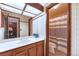 Well lit bathroom with a shower/tub combo and wood vanity at 2013 S Holland St, Lakewood, CO 80227