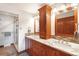 Bathroom featuring double sinks, granite countertops, decorative backsplash and glass enclosed shower at 2013 S Holland St, Lakewood, CO 80227