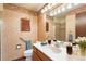 Bathroom featuring a sink, toilet, and shower and patterned wallpaper at 2013 S Holland St, Lakewood, CO 80227